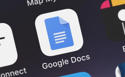 close up shot of Google Docs logo on a screen with a dark background